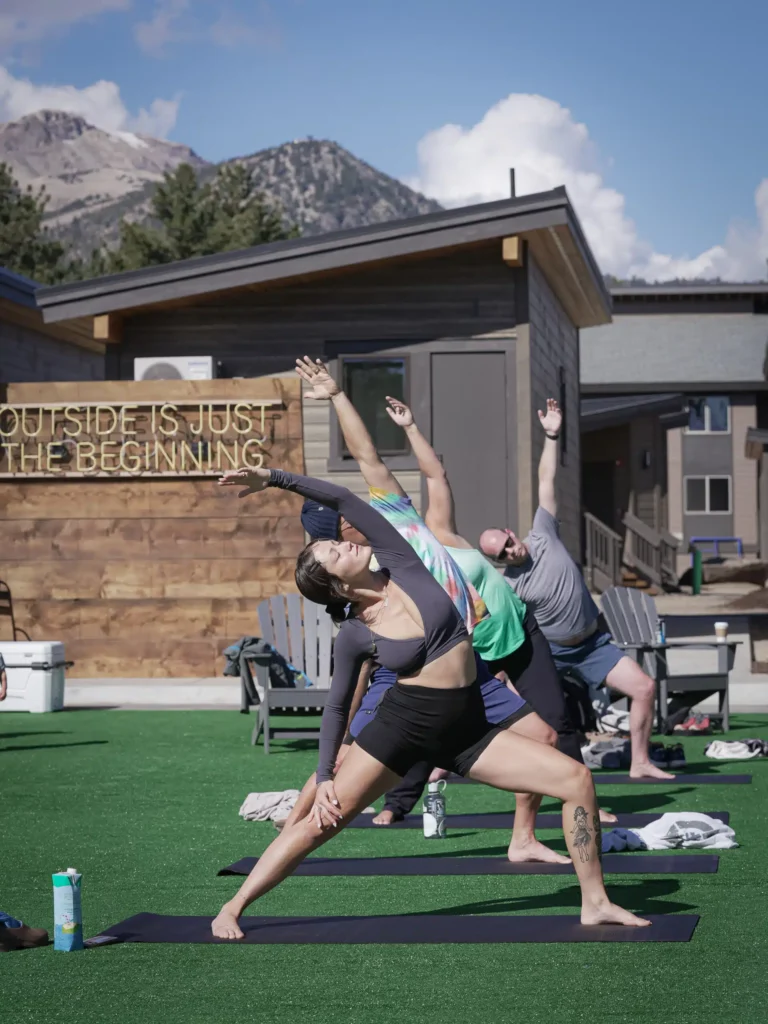 a group of people doing yoga outside