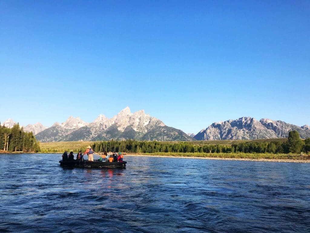 a group of people in a boat on a river