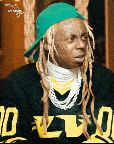 a man wearing a green hat and a black sweatshirt