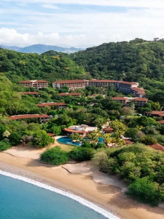 a resort with a pool and trees around it