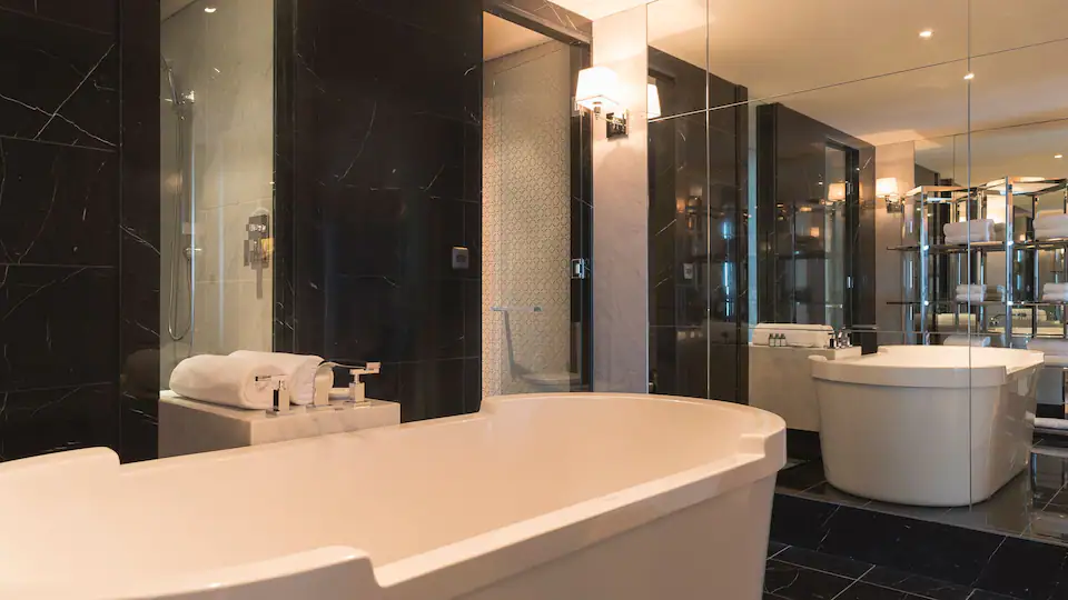 a bathroom with a tub and a mirror