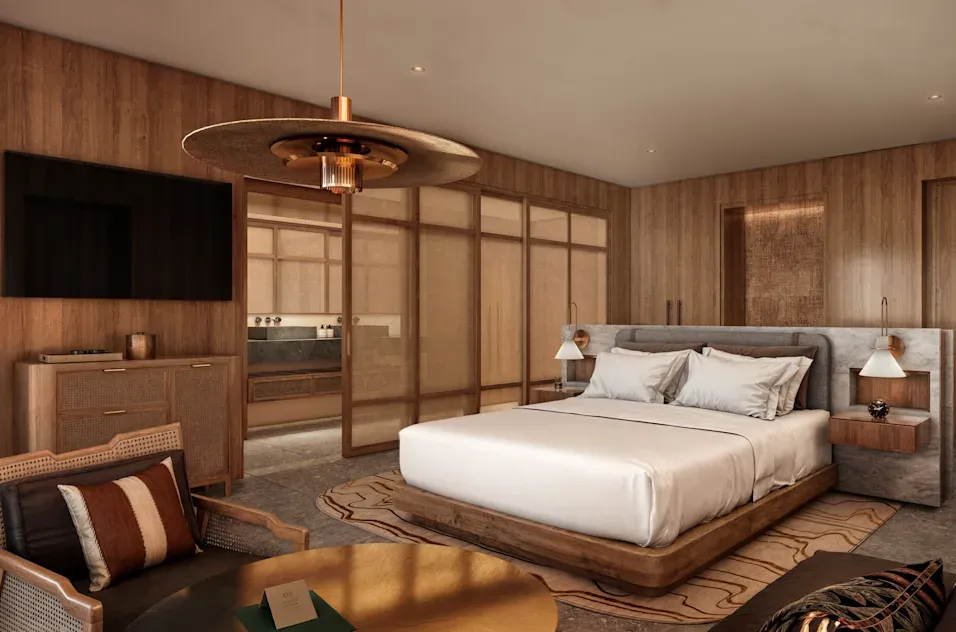 a bedroom with a bed and a television