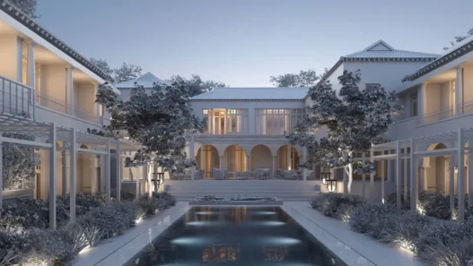 a large white house with a pool in front of it