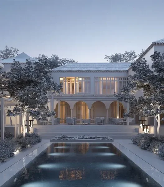 a large white house with a pool in front of it