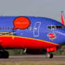 a blue and red airplane on a runway