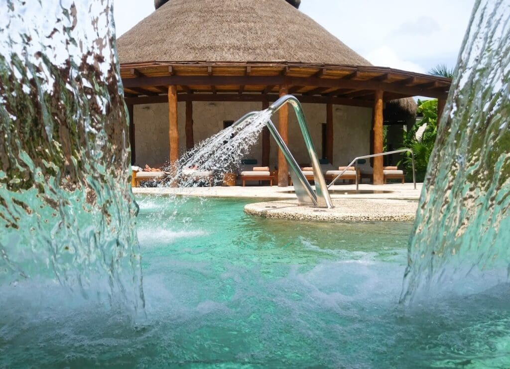 a pool with water splashing out of it