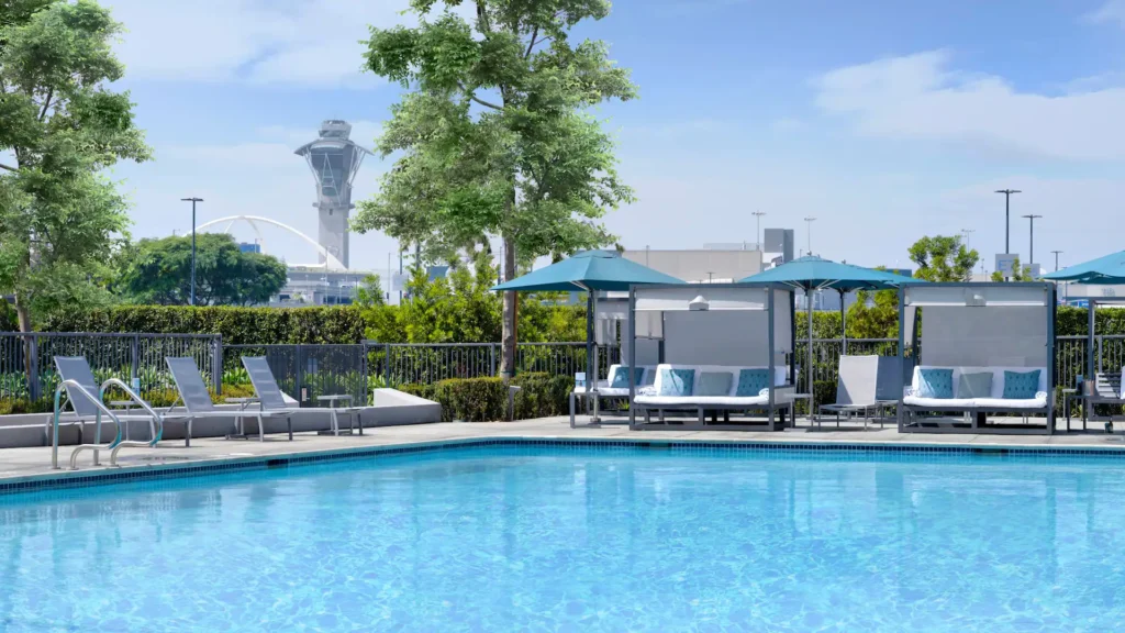 a pool with chairs and umbrellas