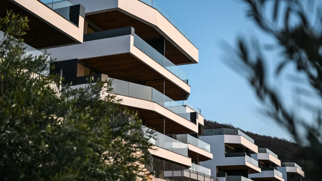 a building with balconies and trees