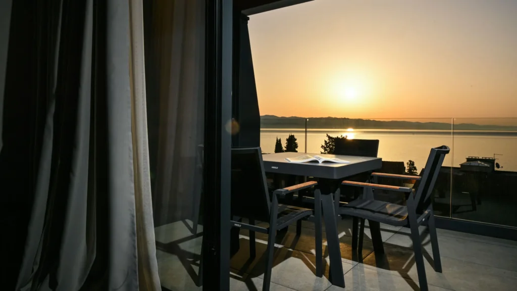 a table and chairs outside a window