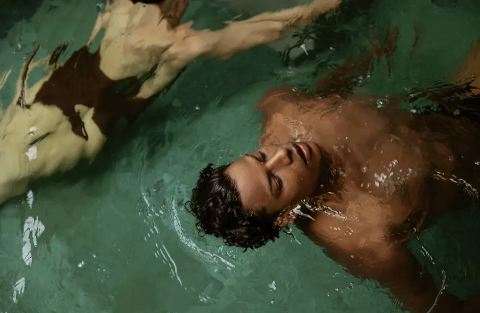 a man floating in a pool
