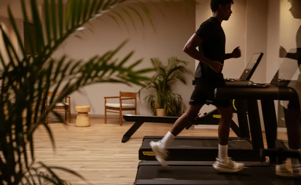 a man running on treadmills in a room