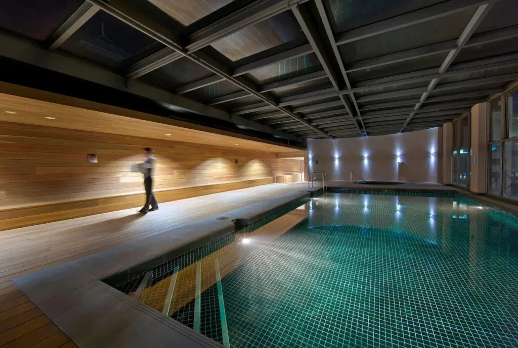 a man walking by a pool
