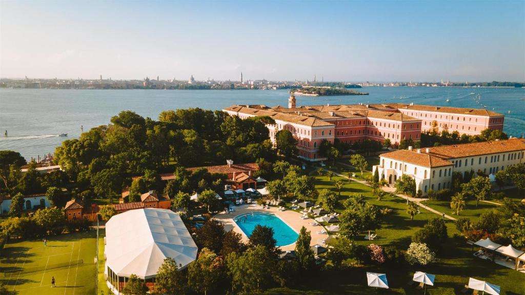 a large building with a pool and trees around it