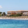 a beach with a building and people on it