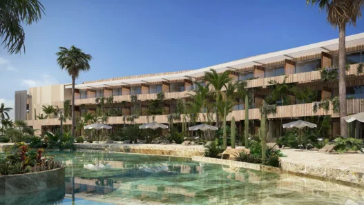 a building with palm trees and a pool