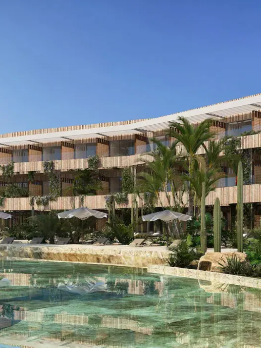 a building with palm trees and a pool