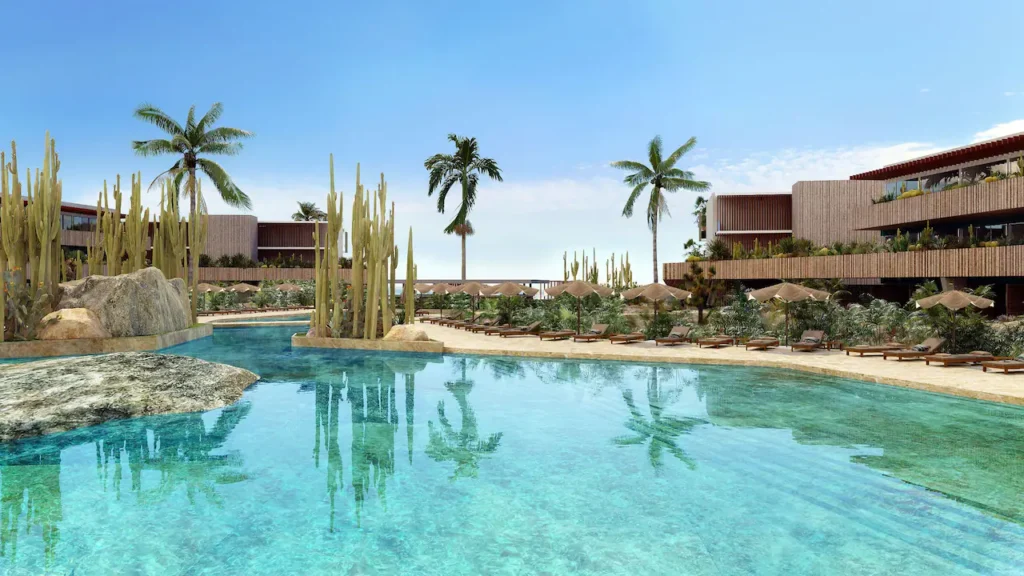 a pool with palm trees and buildings