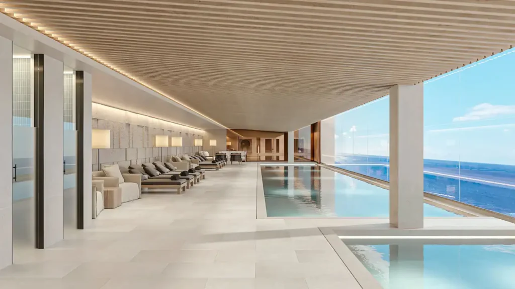a swimming pool with lounge chairs and a large window
