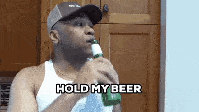 a man in a hat drinking from a bottle