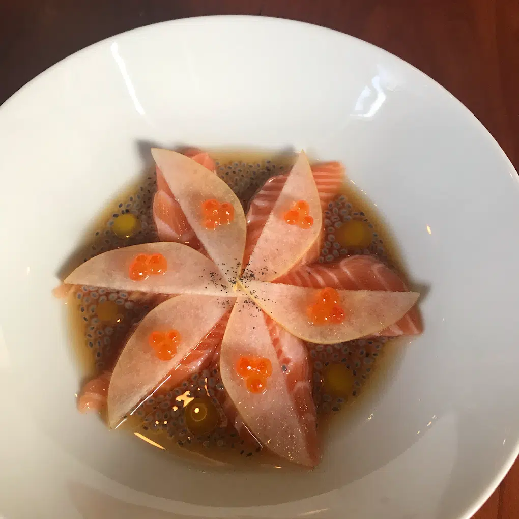 a plate of food with a flower shaped object