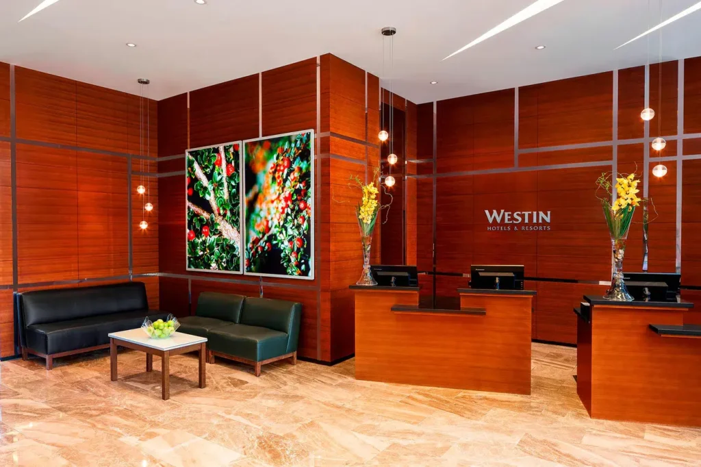a lobby with a reception desk and chairs