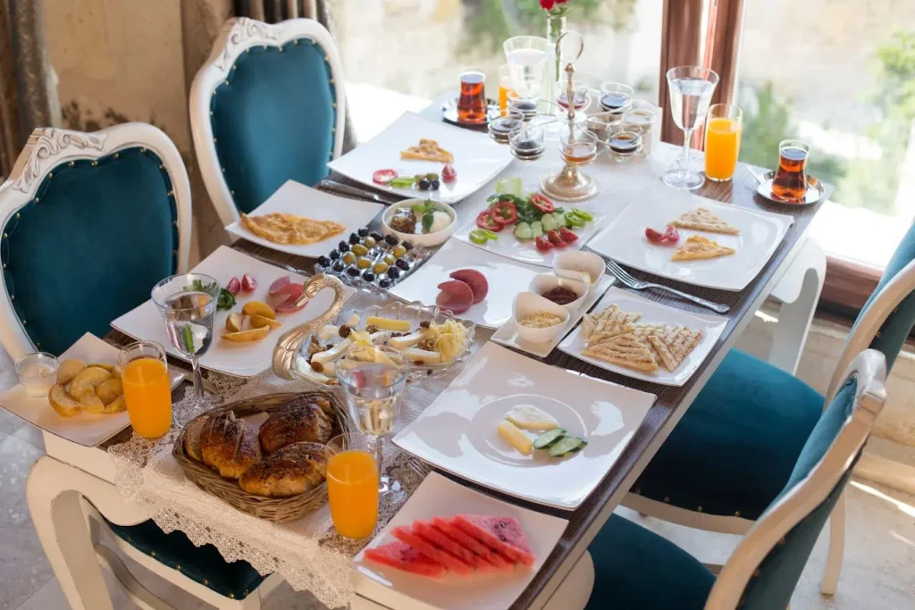 a table with plates of food and drinks