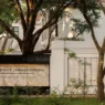 a sign on a wall with trees in the background