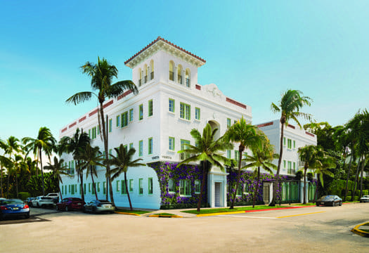 a white building with palm trees