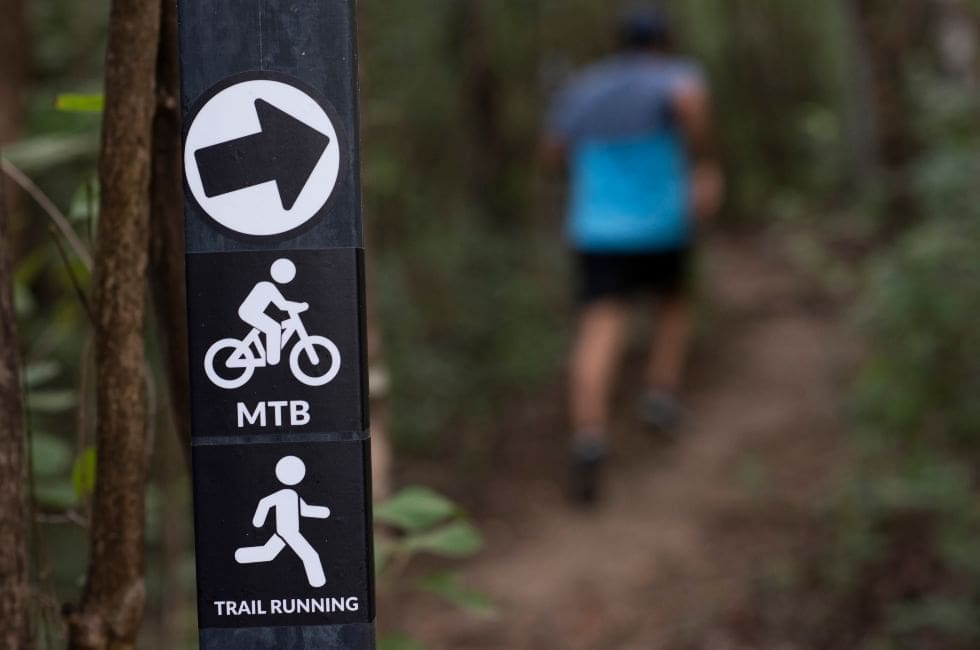 a sign with a person running in the background