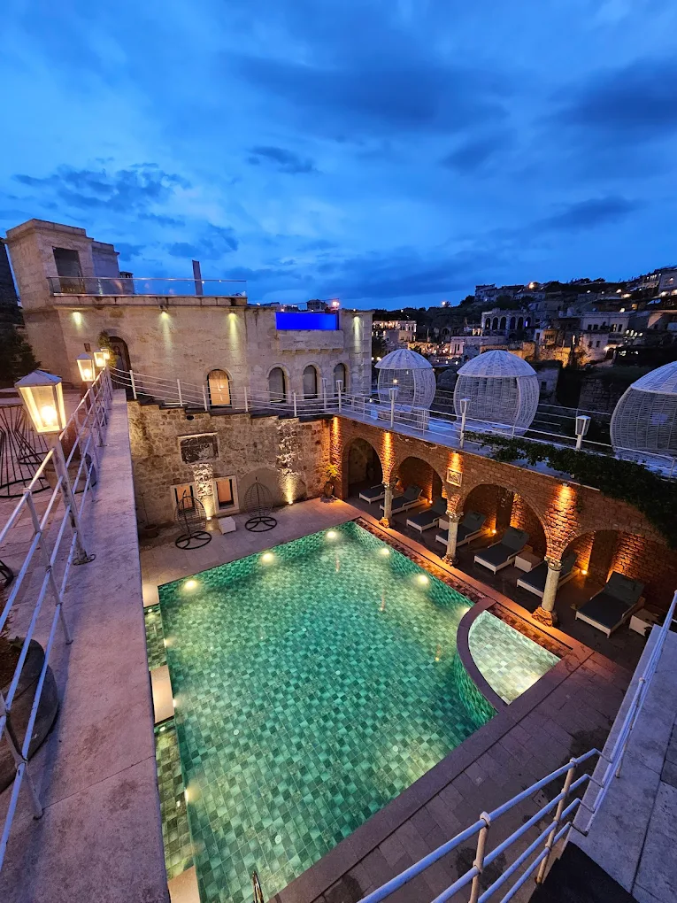 a pool with lights on the side of a building