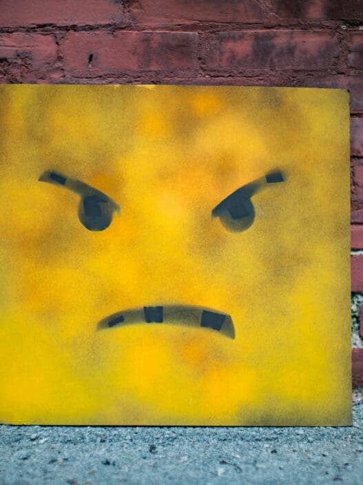a yellow square with a face painted on it