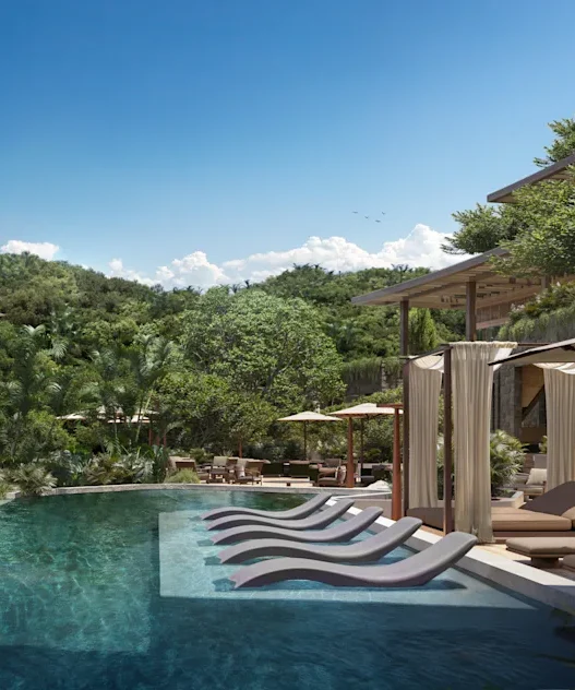 a pool with lounge chairs and trees in the background