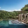 a pool with lounge chairs and trees in the background