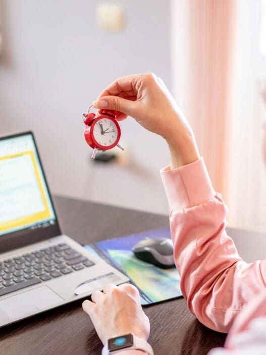 a woman holding a clock in her hand