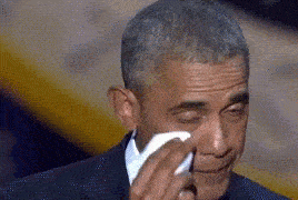 a man wiping his face with a tissue