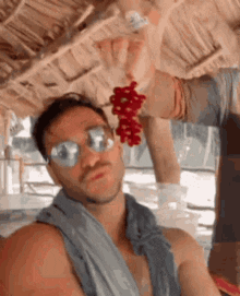 a man wearing sunglasses and a scarf