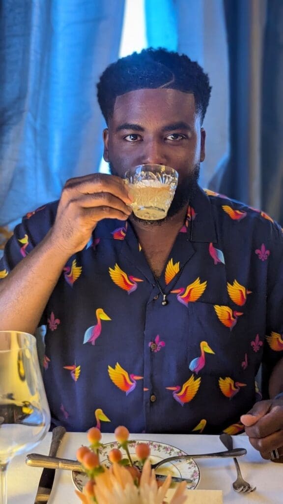 a man drinking from a glass