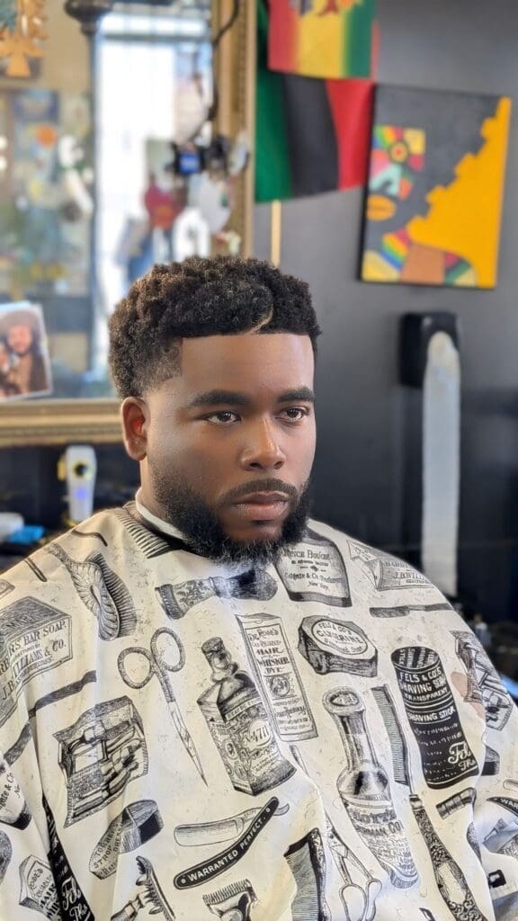 a man sitting in a barber shop