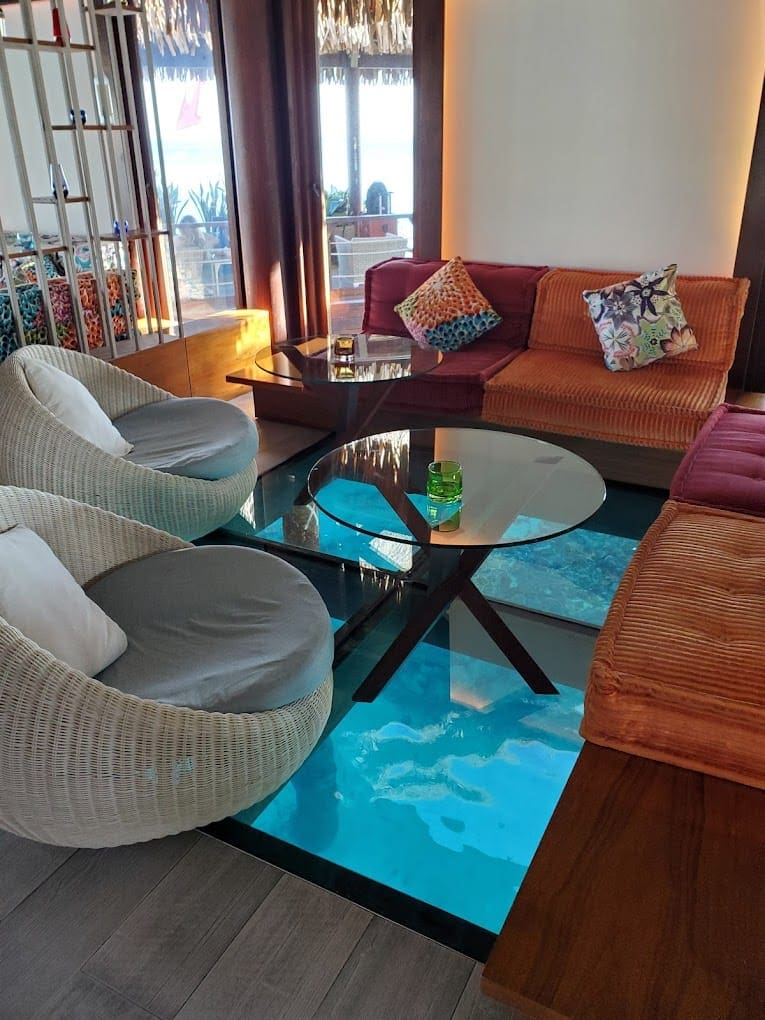 a living room with a glass table and chairs